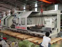 An Annn Yang 1200 x 5000 CNC lathe being place on its shipping skid