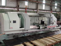 A different view of the Annn Yang CNC lathe being lowered onto its shipping skid